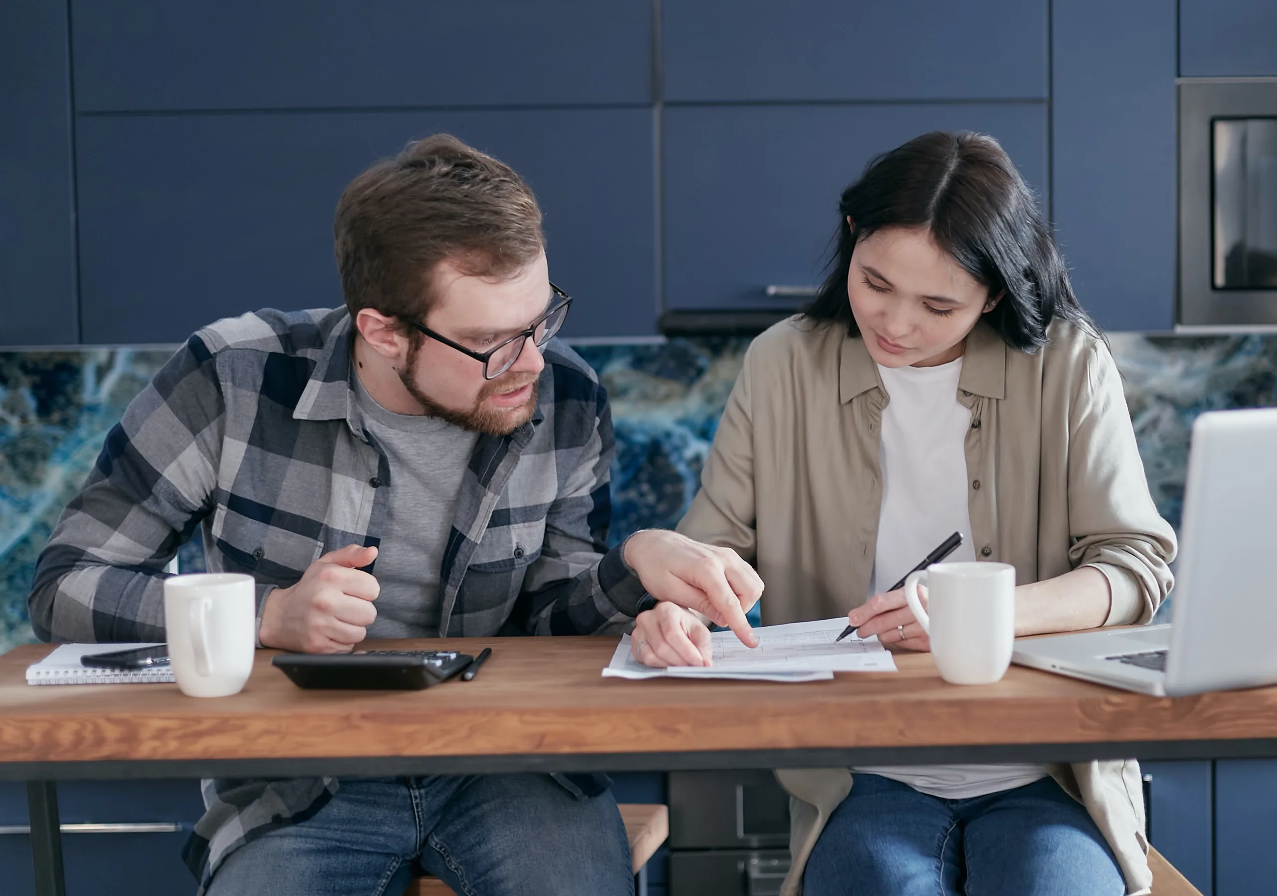 Couple looking over rejected insurance claim documents. 