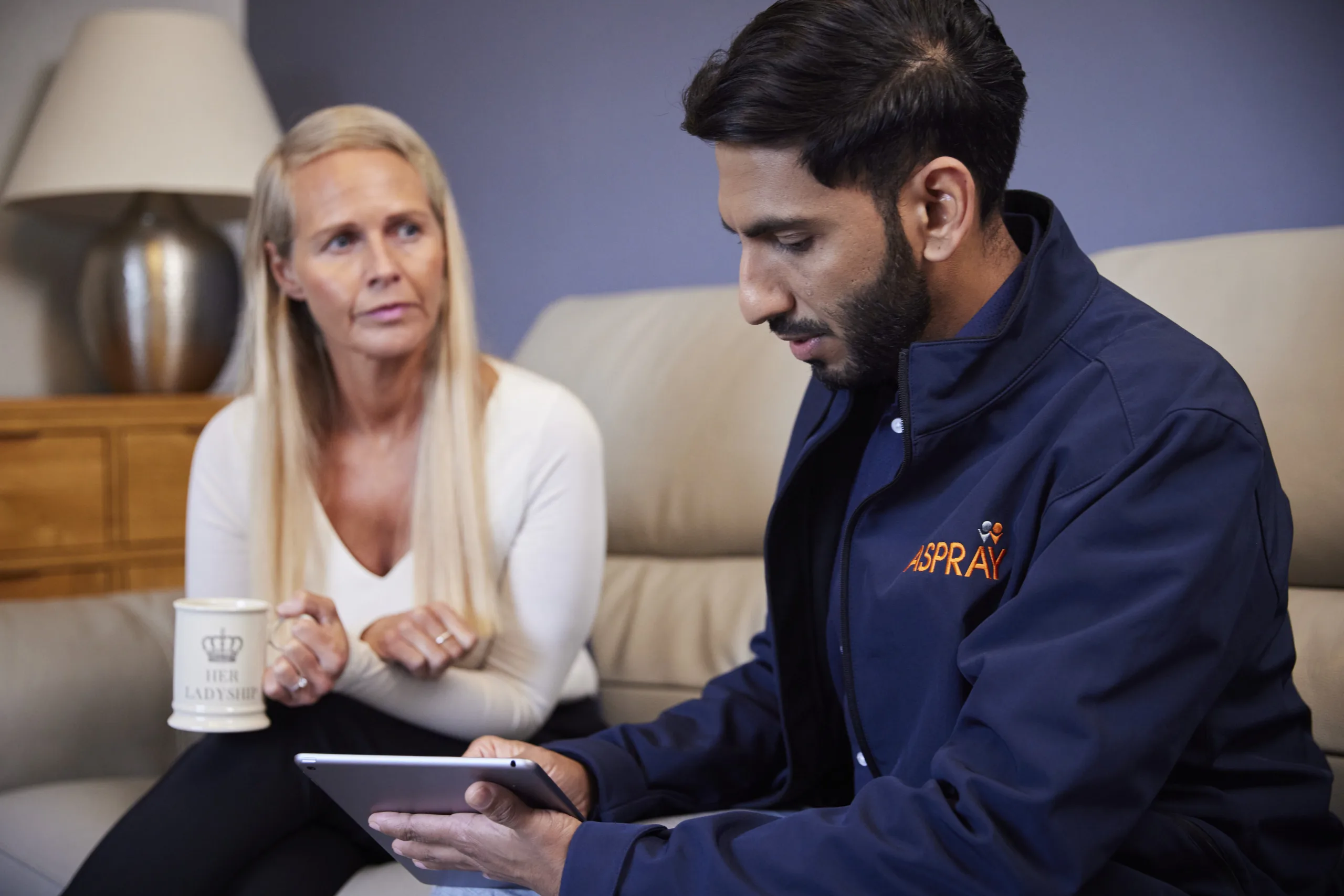 Aspray Loss Assessor talking to a policyholder about the damage to their property and how Aspray can help with the insurance claim. 